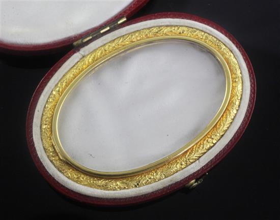 A 19th century glazed oval miniature frame in fitted red leather case, 75mm.